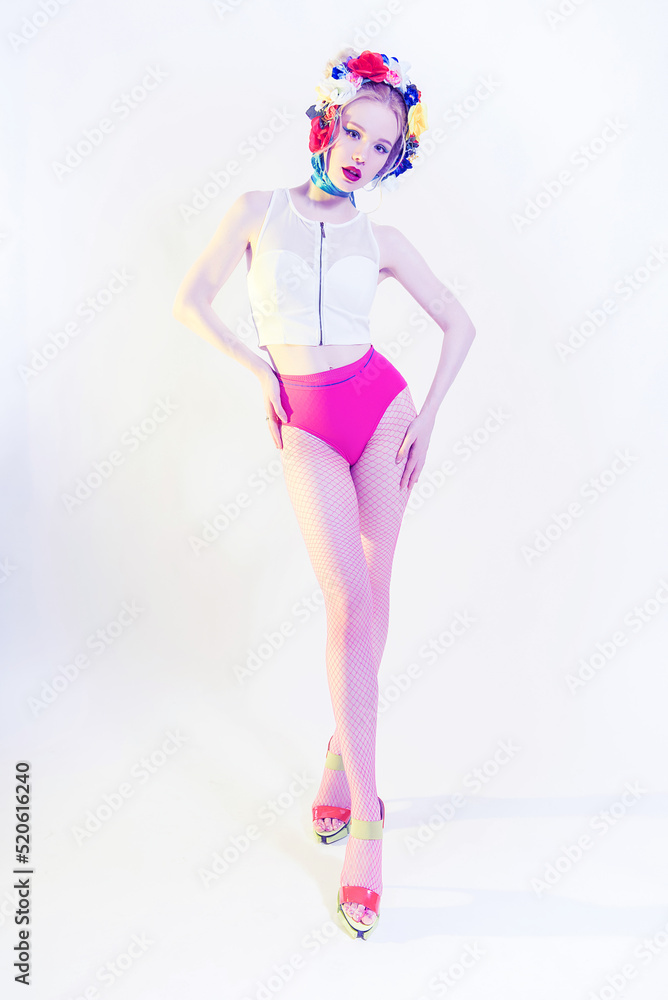 Beautiful Girl With Flowers on the head wearing pink panties and fishnet tights. Perfect Skin. Professional Make-up. Fashion Art. Red lips Beautiful Girl With Flowers on the head wearing pink panties and fishnet tights. Perfect Skin. Professional Make-up. Fashion Art. Red lips