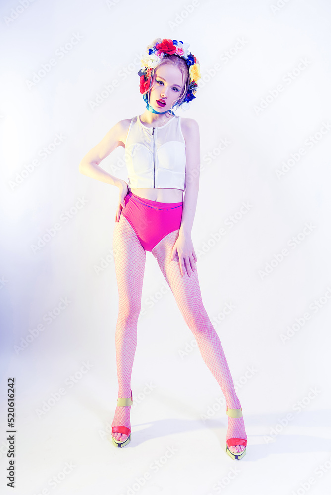 Beautiful Girl With Flowers on the head wearing pink panties and fishnet tights. Perfect Skin. Professional Make-up. Fashion Art. Red lips Beautiful Girl With Flowers on the head wearing pink panties and fishnet tights. Perfect Skin. Professional Make-up. Fashion Art. Red lips