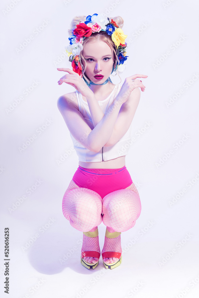 Beautiful Girl With Flowers on the head wearing pink panties and fishnet tights. Perfect Skin. Professional Make-up. Fashion Art. Red lips Beautiful Girl With Flowers on the head wearing pink panties and fishnet tights. Perfect Skin. Professional Make-up. Fashion Art. Red lips