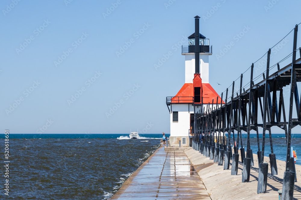 Boat coming in the channel at St. Joseph North Pier Lighthouse, Michigan