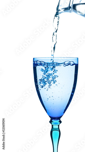 Water pouring into blue and turquoise glass, isolated on white background. Refreshment in the heat. No ice.