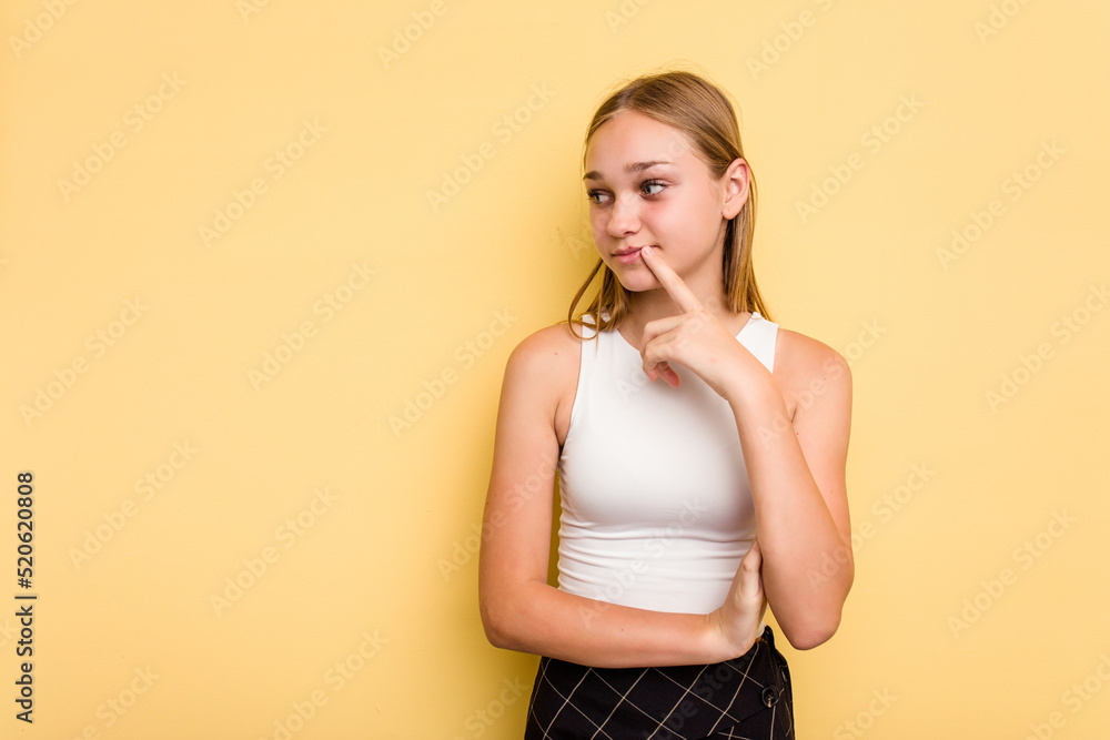 Young caucasian girl isolated on yellow background looking sideways with doubtful and skeptical expression. Young caucasian girl isolated on yellow background looking sideways with doubtful and skeptical expression.