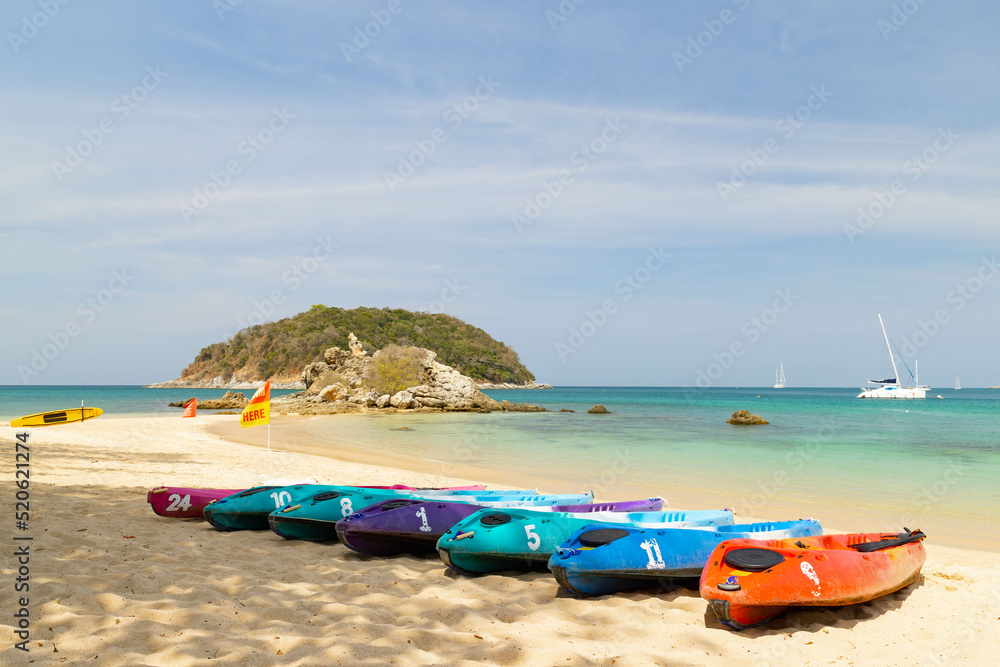A row of kayak ready to be rented at Yanui beach Phuket Thailand, destination tropical beach for tourist with the blue ocean in Thailand