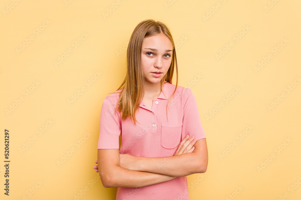 Young caucasian girl isolated on yellow background who is bored, fatigued and need a relax day. Young caucasian girl isolated on yellow background who is bored, fatigued and need a relax day.