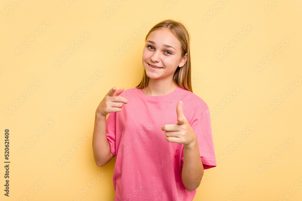 Young caucasian girl isolated on yellow background pointing to front with fingers. Young caucasian girl isolated on yellow background pointing to front with fingers.