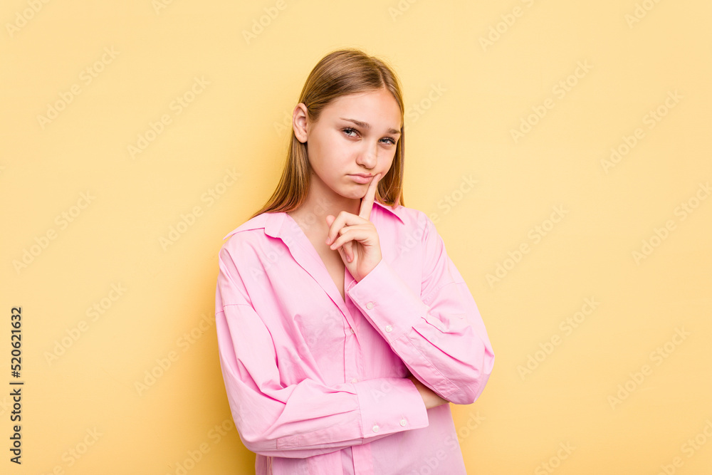 Young caucasian girl isolated on yellow background contemplating, planning a strategy, thinking about the way of a business. Young caucasian girl isolated on yellow background contemplating, planning a strategy, thinking about the way of a business.