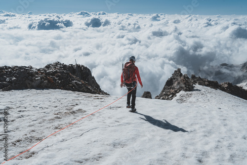 Hiker on glacier descending after successfully summiting Weissmies