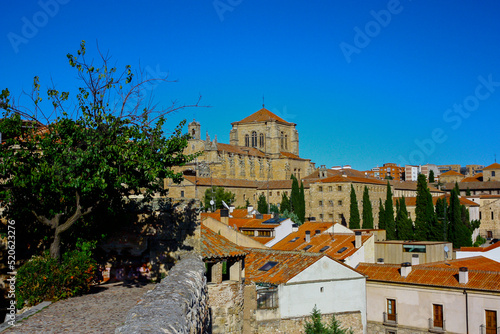 View of the San Esteban convent in Salamanca, Spain, from the Calisto y Melibea garden on a sunny day with a bright blue sky photo