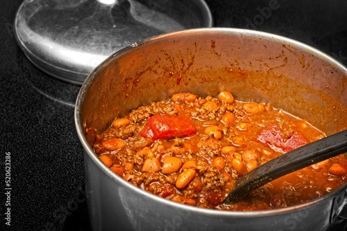 Pot of chili con carne simmering on stovetop