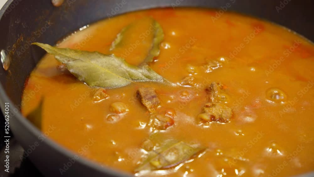 Cooking pieces of beef meat in sauce. Tomato sauce goulash with bay leaf spice Cooking pieces of beef meat in sauce. Tomato sauce goulash with bay leaf spice