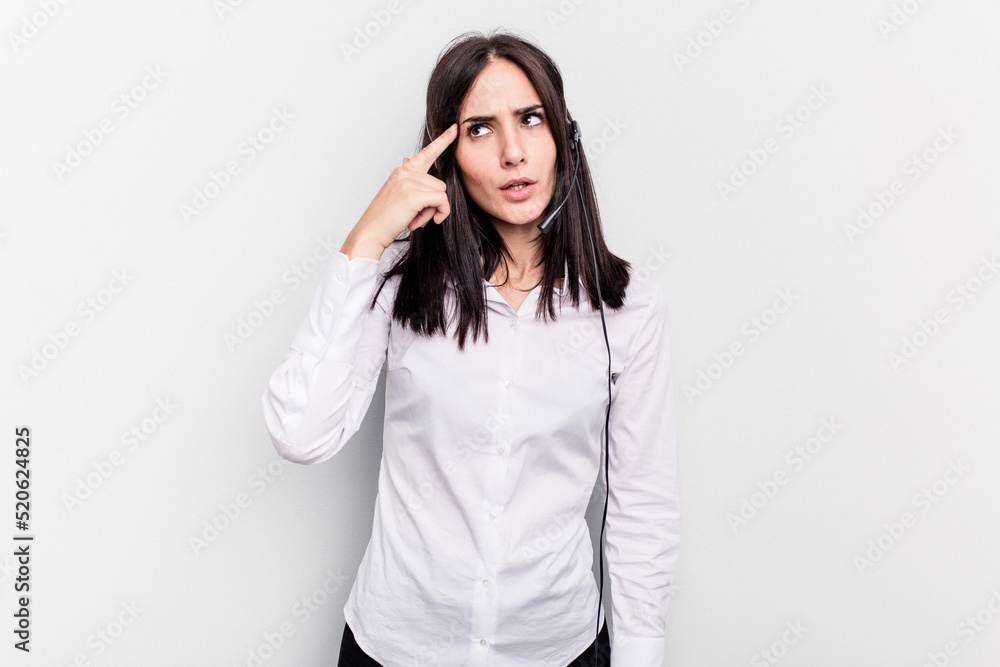 Telemarketer caucasian woman working with a headset isolated on white background showing a disappointment gesture with forefinger. Telemarketer caucasian woman working with a headset isolated on white background showing a disappointment gesture with forefinger.