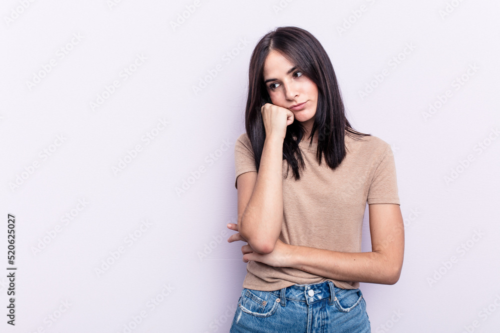 Young caucasian woman isolated on pink background who feels sad and pensive, looking at copy space. Young caucasian woman isolated on pink background who feels sad and pensive, looking at copy space.
