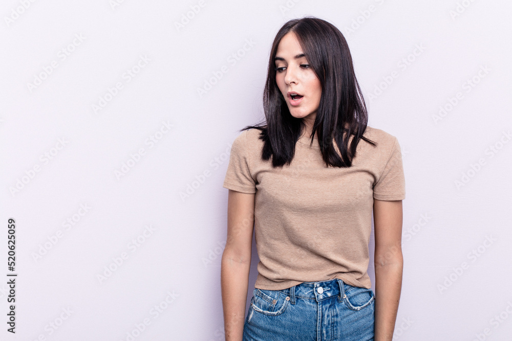 Young caucasian woman isolated on pink background being shocked because of something she has seen. Young caucasian woman isolated on pink background being shocked because of something she has seen.