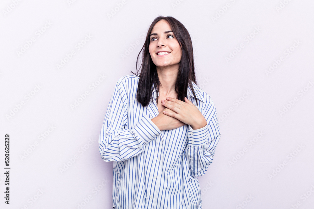 Young caucasian woman isolated on pink background has friendly expression, pressing palm to chest. Love concept. Young caucasian woman isolated on pink background has friendly expression, pressing palm to chest. Love concept.
