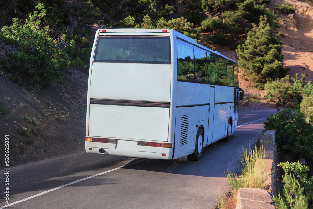 Tourist bus moves along mountain road
