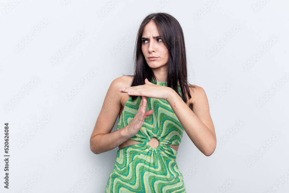 Young caucasian woman isolated on white background showing a timeout gesture.