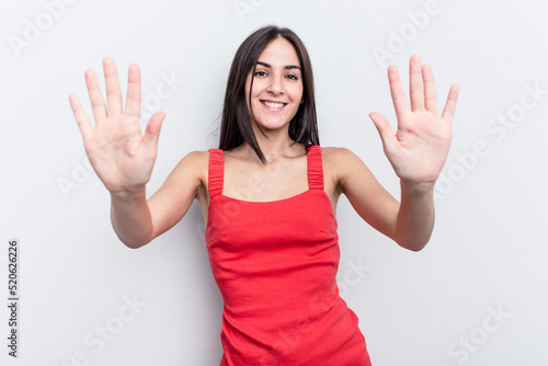 Young caucasian woman isolated on white background showing number ten with hands.
