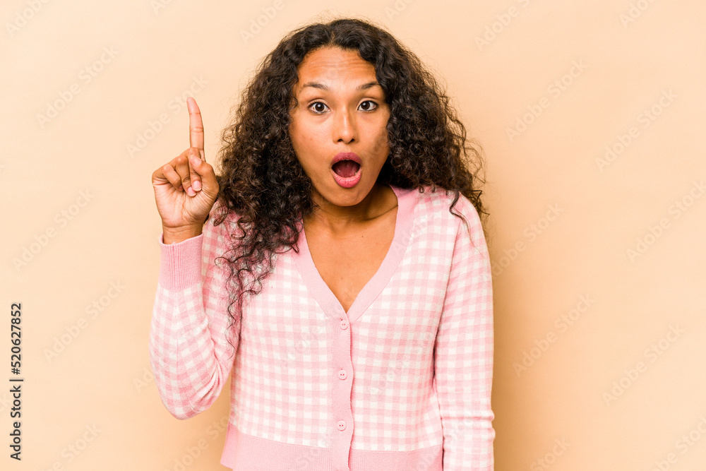 Young hispanic woman isolated on beige background having some great idea, concept of creativity. Young hispanic woman isolated on beige background having some great idea, concept of creativity.