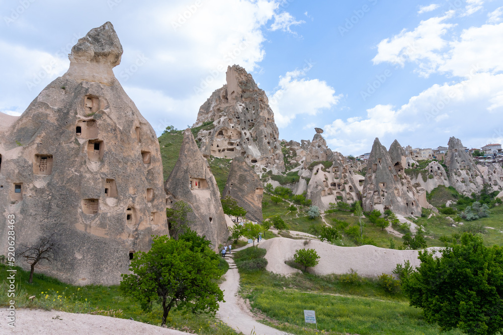 Landscape of Uchisar in Cappadocia, with the typical rocks, on a day with many clouds in the sky