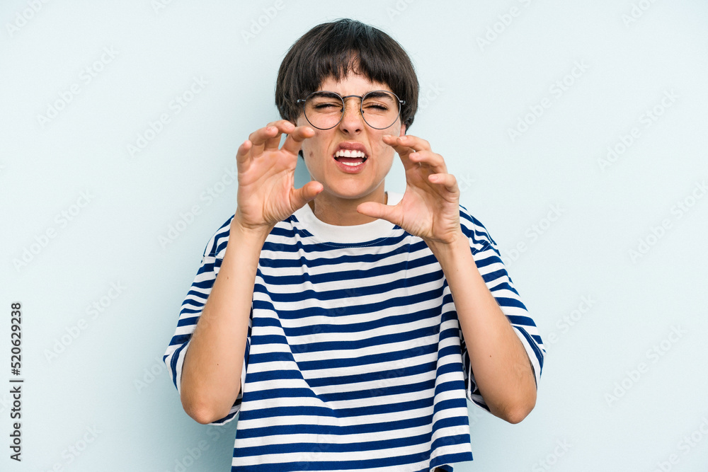 Young caucasian woman with a short hair cut isolated showing claws imitating a cat, aggressive gesture. Young caucasian woman with a short hair cut isolated showing claws imitating a cat, aggressive gesture.