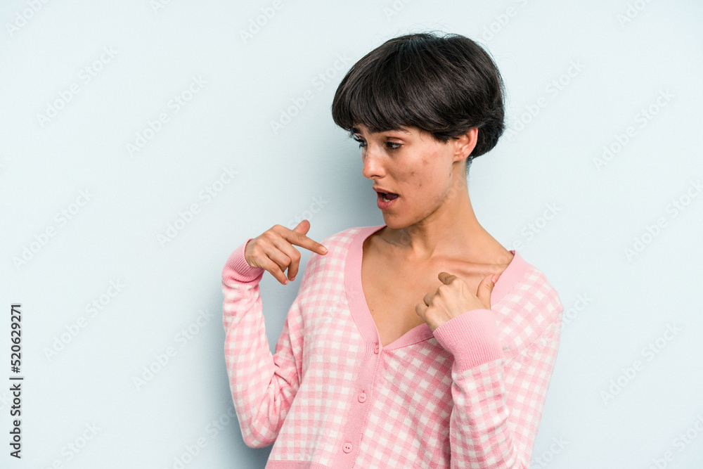 Young caucasian woman with a short hair cut isolated surprised pointing with finger, smiling broadly. Young caucasian woman with a short hair cut isolated surprised pointing with finger, smiling broadly.