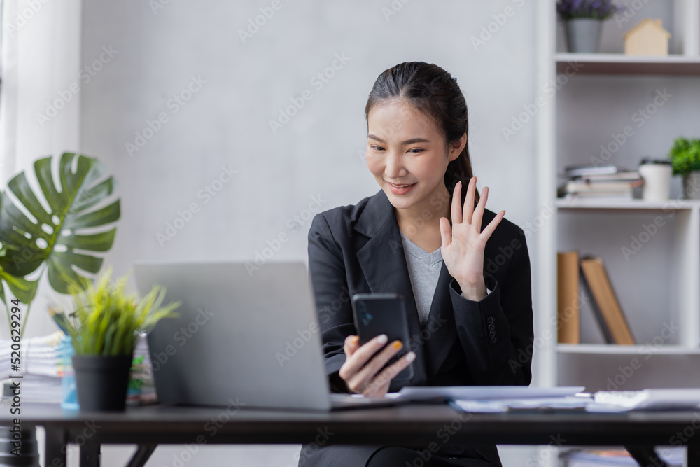 Happy young Asian woman using the phone texting messaging on a smartphone, smiling girl using cellphone chatting, browsing wireless internet on gadget at work please Happy young Asian woman using the phone texting messaging on a smartphone, smiling girl using cellphone chatting, browsing wireless internet on gadget at work please