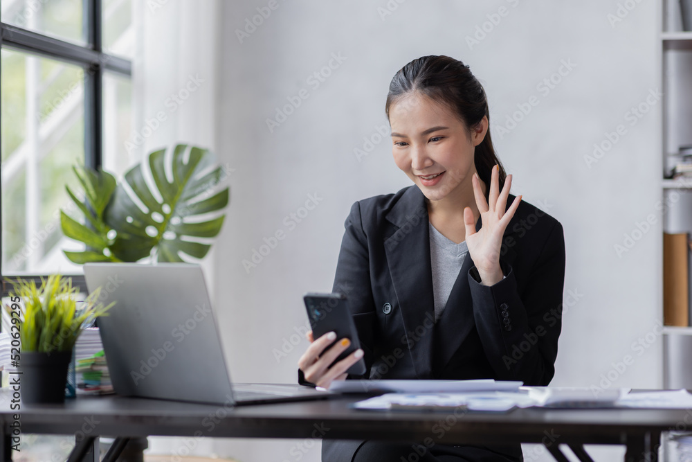 Happy young Asian woman using the phone texting messaging on a smartphone, smiling girl using cellphone chatting, browsing wireless internet on gadget at work please Happy young Asian woman using the phone texting messaging on a smartphone, smiling girl using cellphone chatting, browsing wireless internet on gadget at work please