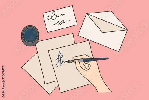 Person writing letter with pen