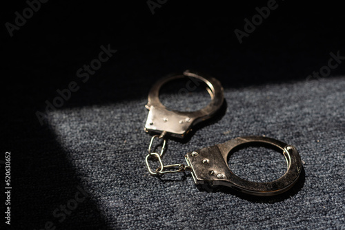 the black handcuffs on wooden background. criminal justice