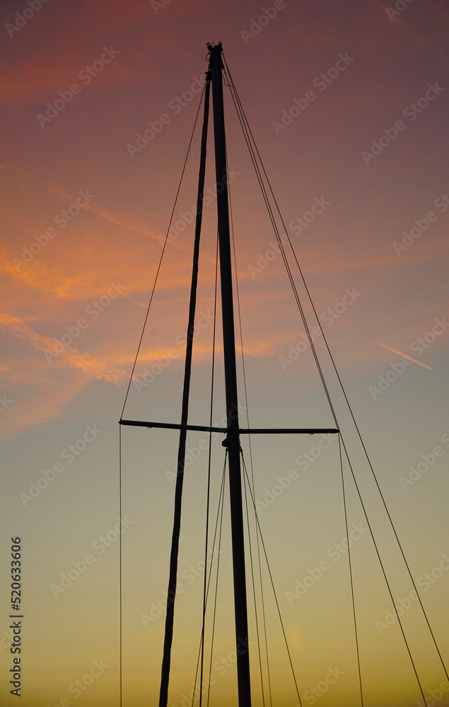 Construction on top of a sailing ship without sails at dusk