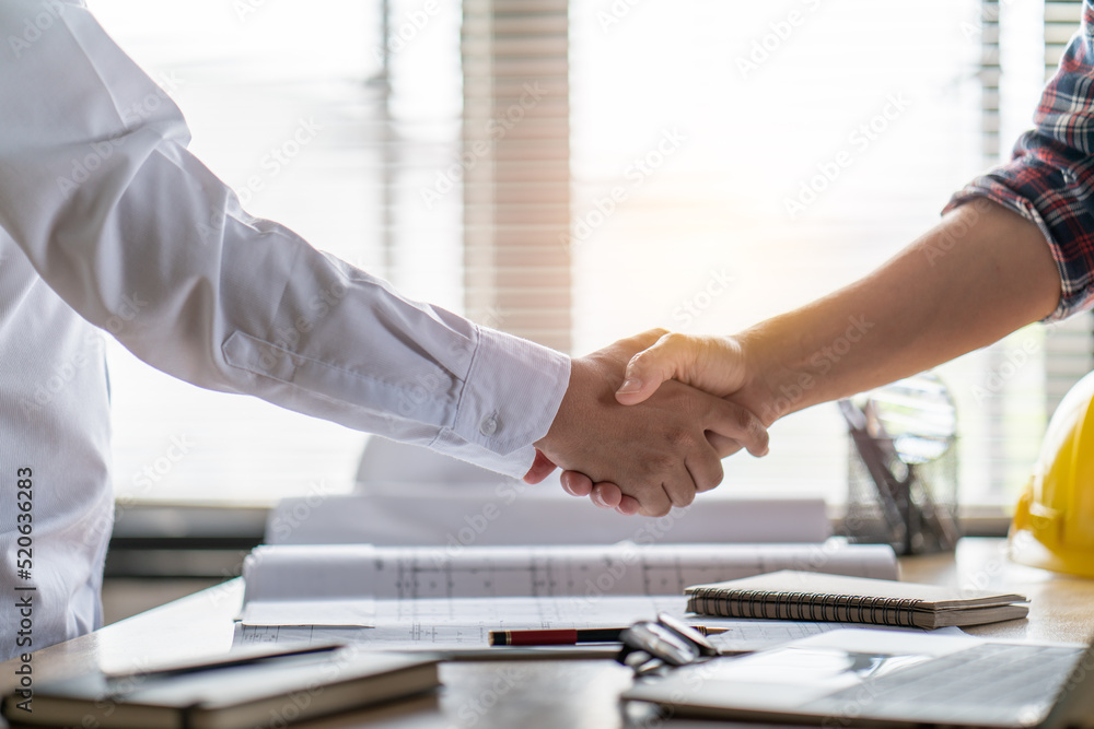 Engineer constructor handshake meeting with architect owner for agreement in contract building home project Engineer constructor handshake meeting with architect owner for agreement in contract building home project
