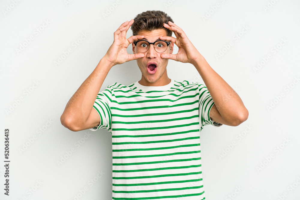 Young caucasian man isolated on white background keeping eyes opened to find a success opportunity. Young caucasian man isolated on white background keeping eyes opened to find a success opportunity.