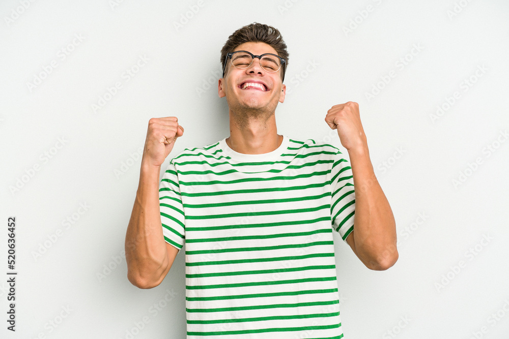 Young caucasian man isolated on white background celebrating a victory, passion and enthusiasm, happy expression. Young caucasian man isolated on white background celebrating a victory, passion and enthusiasm, happy expression.