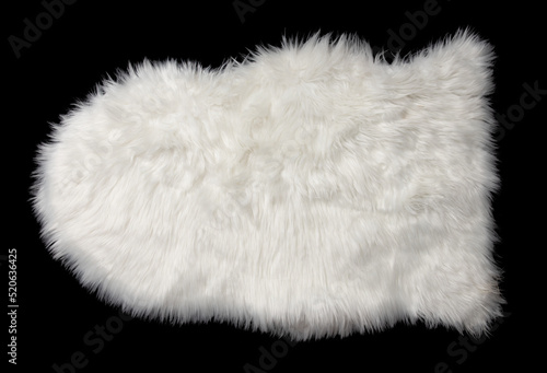 White sheep skin isolated on a black background.
