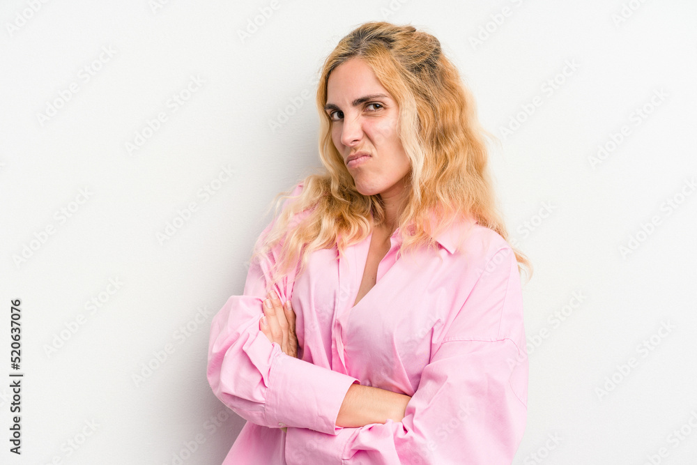 Young caucasian woman isolated on white background frowning face in displeasure, keeps arms folded. Young caucasian woman isolated on white background frowning face in displeasure, keeps arms folded.