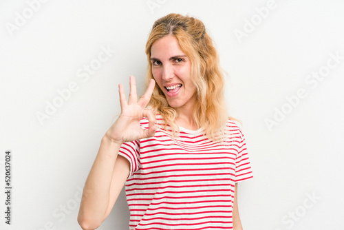 Young caucasian woman isolated on white background cheerful and confident showing ok gesture.