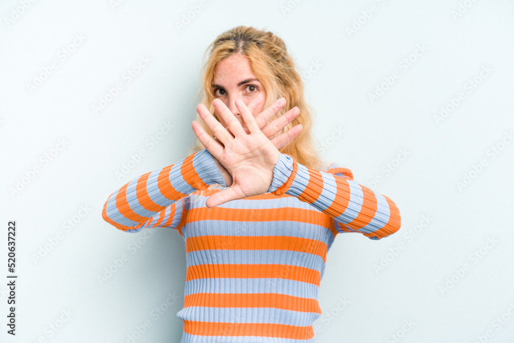 Young caucasian woman isolated on blue background doing a denial gesture Young caucasian woman isolated on blue background doing a denial gesture