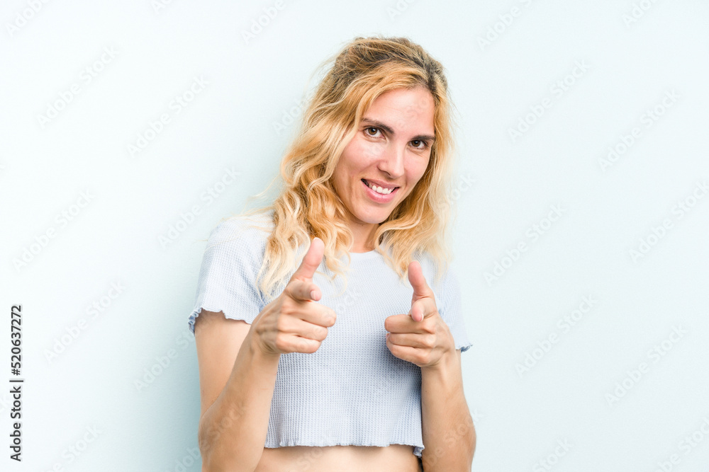 Young caucasian woman isolated on blue background pointing to front with fingers. Young caucasian woman isolated on blue background pointing to front with fingers.