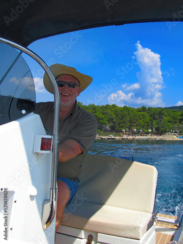 man relaxed on a motorboat tour photo