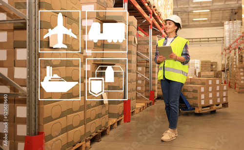 Tablou pe pânză Illustration of shipping icons and woman with tablet working at warehouse