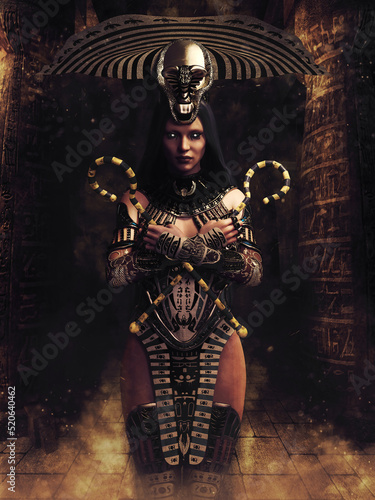 Fotografie Fantasy priestess in an ancient Egyptian outfit, holding two staffs in her hands