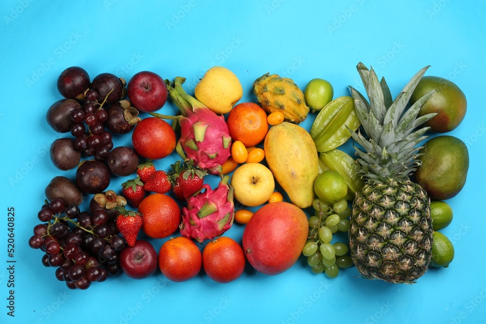 Assortment of fresh exotic fruits on light blue background, flat lay Assortment of fresh exotic fruits on light blue background, flat lay