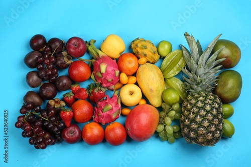 Fototapeta Naklejka Na Ścianę i Meble -  Assortment of fresh exotic fruits on light blue background, flat lay