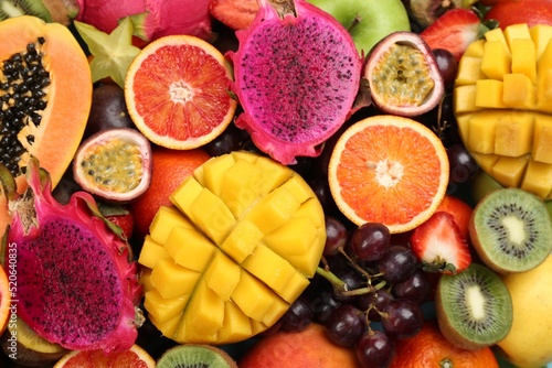 Fototapeta Naklejka Na Ścianę i Meble -  Many different delicious exotic fruits as background, top view