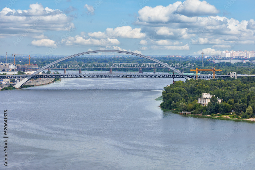 Naklejka premium View of the new automobile cable-stayed bridge across the Dnipro river in Kyiv on a summer day.