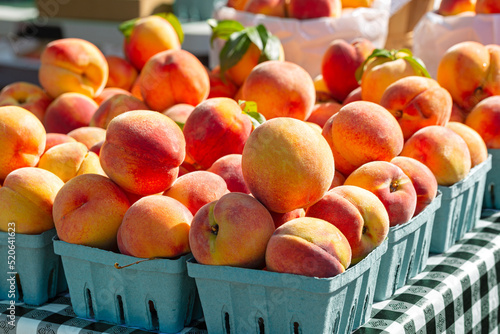 Close-up of fresh yellow peaches in early morning light at a local farmer's market in West Virginia USA photo