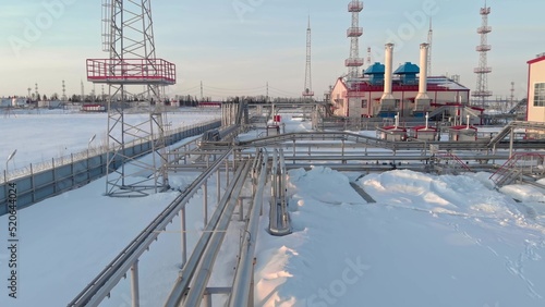 Winter oil and gas refinery plant in siberia. The drone flies over the gas pipeline feeding the gas turbine power plant. World energy crisis. Green Energy Program to Solve Fossil Fuel Problems