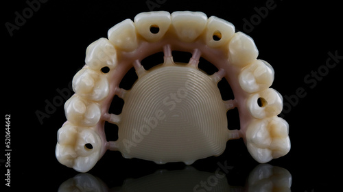 Morphology of prosthesis made of milled zircon with a painted gum on a black background