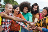Young group of people stacking hands together outdoor - Diversity friends concept