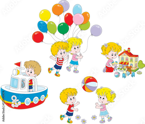 Happy little girl and boy playing a colorful ball, with a dollhouse, a toy boat and balloons
